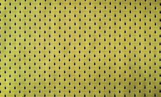 dichtbij omhoog van geel polyester nylon- geel sportkleding shorts naar gemaakt een getextureerde achtergrond foto