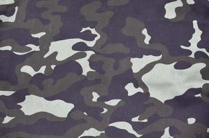 structuur van kleding stof met een camouflage geschilderd in kleuren van de moeras. leger achtergrond beeld foto