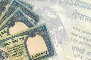 50 nepalese roepies rekeningen leugens in stack Aan achtergrond van groot semi-transparant bankbiljet. abstract bedrijf achtergrond foto