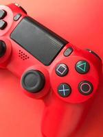 mooi rood digitaal modern nieuw spel bedieningshendel voor computer video spellen gamepad Aan een rood achtergrond foto