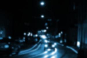 wazig nacht tafereel van verkeer Aan de rijweg. onscherp beeld van auto's op reis met lichtgevend koplampen. bokeh kunst foto