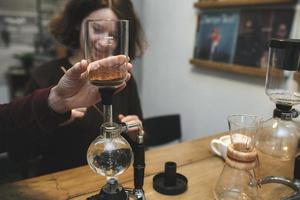 wijnoogst paar voorbereidingen treffen koffie met vacuüm koffie maker.koffie winkel foto