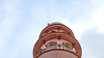 moskee toren gezien van hieronder met blauw lucht in de achtergrond foto