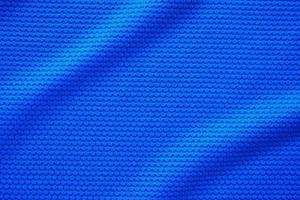 blauw Amerikaans voetbal Jersey kleding kleding stof structuur sport- slijtage achtergrond, dichtbij omhoog top visie foto