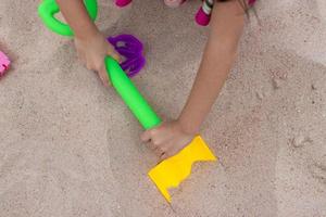 kinderen spelen in de zand in de buurt de strand foto