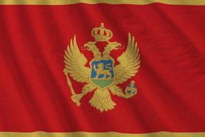 Montenegro vlag met groot vouwen golvend dichtbij omhoog onder de studio licht binnenshuis. de officieel symbolen en kleuren in banier foto