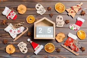 top visie van kalender Aan Kerstmis houten achtergrond. de twintig vijfde van december. nieuw jaar speelgoed en decoraties. vakantie concept foto