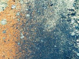 steen textuur. kant een deel van een steen graniet ring. grijs, oranje achtergrond kleur met beige klein vlekken. de structuur is heterogeen, mat, met klein stenen. natuurlijk structuur foto