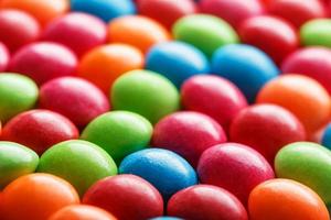 regenboog kleuren van veelkleurig snoepjes detailopname, structuur en herhaling van dragee foto