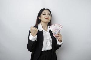 een portret als een jong zakenvrouw met een stack van geld in Indonesisch roepia in haar handen geïsoleerd door wit achtergrond foto