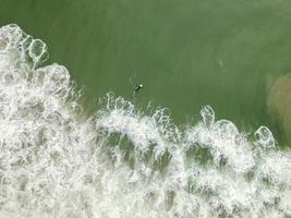 luchtfotografie van een eenzame surfer in water foto