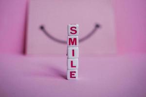 glimlach woord Aan de roze achtergrond, gevoelens en emoties foto