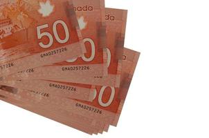 50 Canadees dollars rekeningen leugens in klein bundel of pak geïsoleerd Aan wit. mockup met kopiëren ruimte. bedrijf en valuta uitwisseling foto