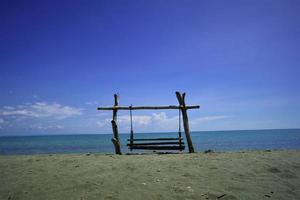 strand schommel blauw lucht foto