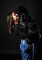 een meisje houdt een labrador retriever-hond in haar armen. foto