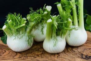 groene en witte venkelbollen op olijfhout foto