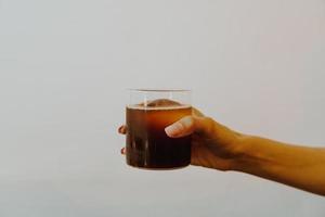 zwart koffie verkoudheid druppelen in glas foto