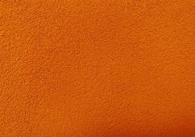 naadloos structuur van oranje cement muur een ruw oppervlak, met ruimte voor tekst, voor een achtergrond. foto