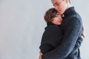 schattig jong paar omarmen elk andere binnenshuis in de studio foto