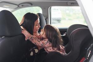 omarmen elk ander. moeder met haar dochter binnen van modern auto- samen foto