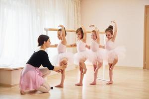 beoefenen houding. weinig ballerina's voorbereidingen treffen voor prestatie foto