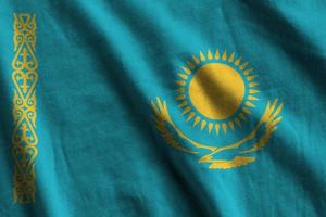 Kazachstan vlag met groot vouwen golvend dichtbij omhoog onder de studio licht binnenshuis. de officieel symbolen en kleuren in banier foto