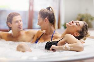 groep van vrienden genieten van jacuzzi in hotel spa foto