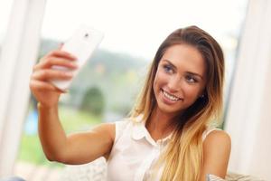 vrouw Aan bankstel in leven kamer nemen selfie foto