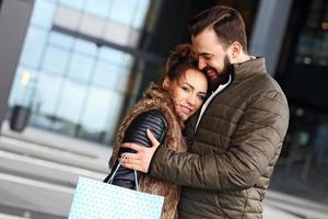 gelukkig paar boodschappen doen en knuffelen foto