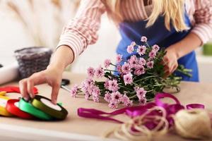 vrouw bloemist werken in bloem winkel foto