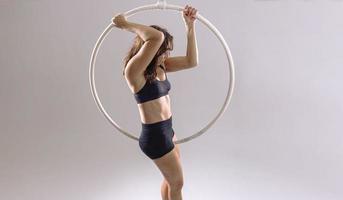een vrouw antenne hoepel gymnast het uitvoeren van opdrachten Aan een antenne hoepel foto