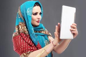 Arabisch vrouw gebruik makend van tablet foto