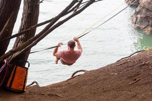 slackliner in koraal gekleurde overhemd glijden langs de lijn foto