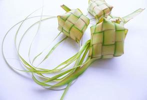 ketupat in aardewerk bord geïsoleerd Aan wit achtergrond. ketupat ,rijst knoedel is voedsel geserveerd wanneer idhul fitri eid mubarak in Indonesië, gemaakt van rijst- verpakt in jong kokosnoot bladeren, janur foto