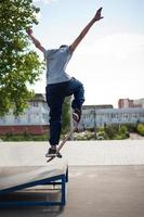 skateboarder doet de truc met een springen Aan de oprit. skateboarder vliegend in de lucht foto