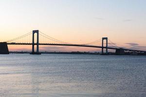 zonsondergang over- lang eiland geluid en troebelen nek brug in nieuw york stad. foto