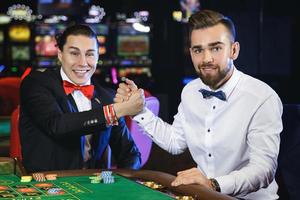 knap jongens spelen roulette in de casino foto