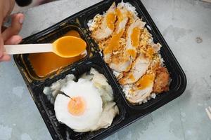 kerrie kip en rijst- in een nemen weg plastic pakket Aan tafel foto