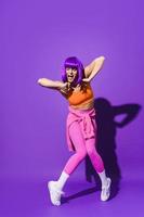 zorgeloos vrouw danser vervelend kleurrijk sportkleding het uitvoeren van tegen Purper achtergrond foto