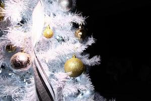 glimmend goud en zilver Kerstmis bollen Aan Kerstmis boom met ruimte voor tekst foto