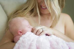 jong mooi moeder Holding haar kostbaar pasgeboren baby meisje foto