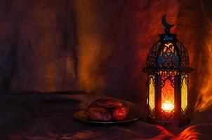 zwart lantaarn en datums fruit Aan donker achtergrond voor de moslim feest van de heilig maand van Ramadan kareem. foto