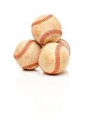 vier honkballen geïsoleerd Aan reflecterende wit foto