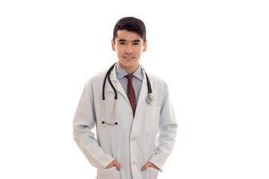 studio portret van vrolijk mannetje dokter in uniform poseren geïsoleerd Aan wit achtergrond foto