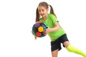 gelukkig weinig meisje met veelkleurig voetbal bal in haar handen foto