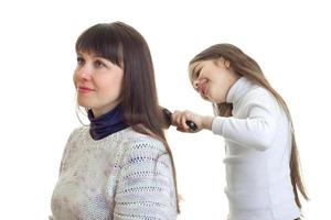 dochter kammen een lang haar- van haar moeder foto