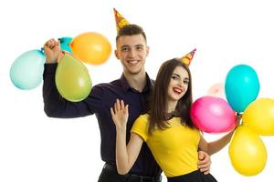 vrolijk jong paar met ballonnen in hun handen glimlachen foto