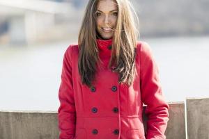 mooi jong vrouw in rood jas foto