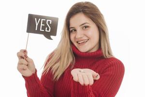 vrouw Holding verloving ring en teken gezegde Ja foto