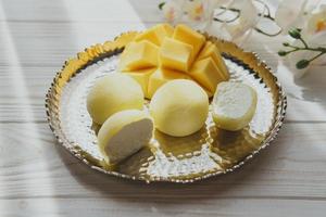 smakelijk toetje mochi met mango fruit Aan houten achtergrond foto